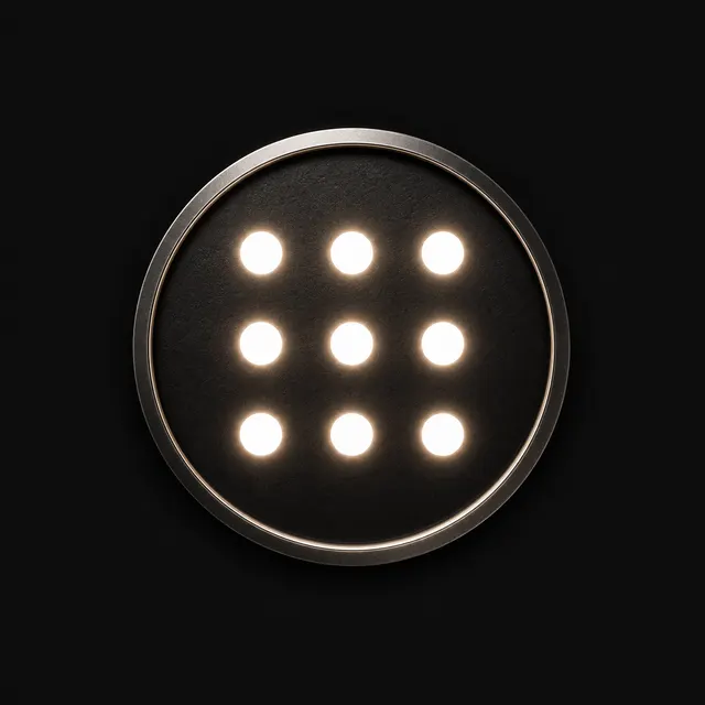 Circular emblem of nine small lights in a three-by-three grid.